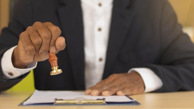 Business man person s hand stamping with approved stamp certificate document public paper desk signing business partner paper success concept attorney insurance 748791